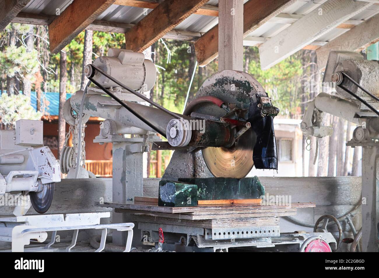 A large steel blade cuts through a block of jade Stock Photo Alamy