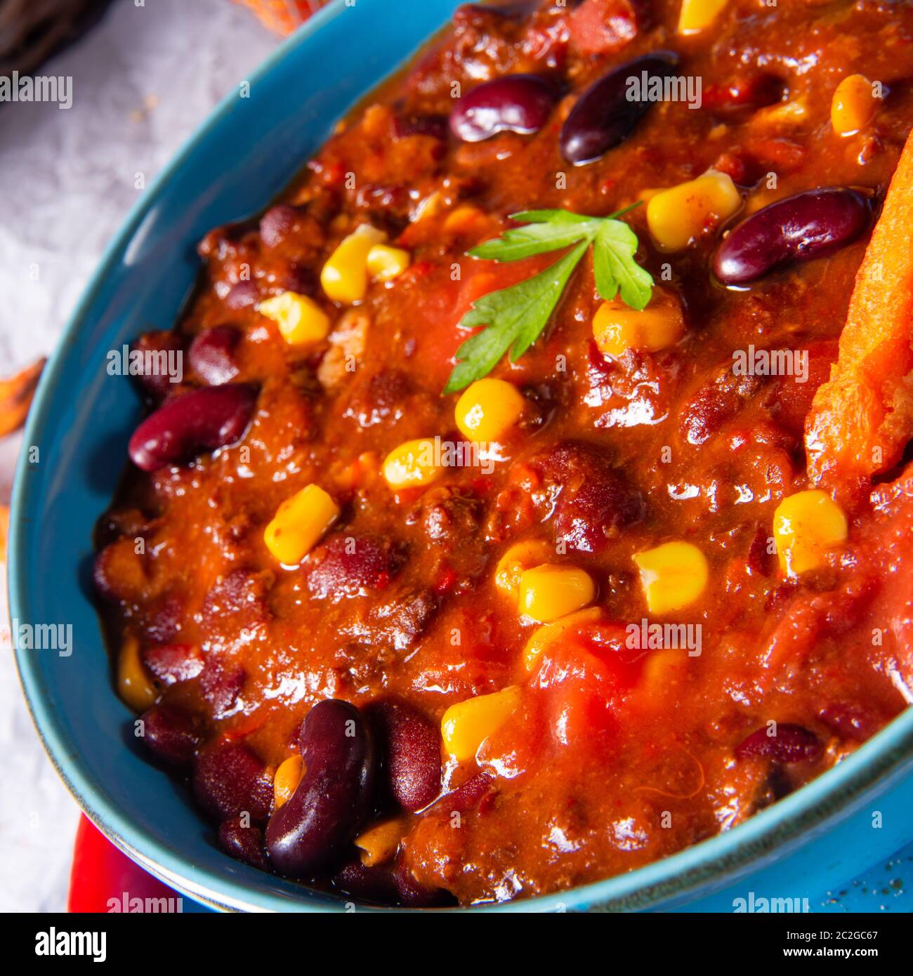 chili con carne with sweet potato and spicy nachos Stock Photo Alamy