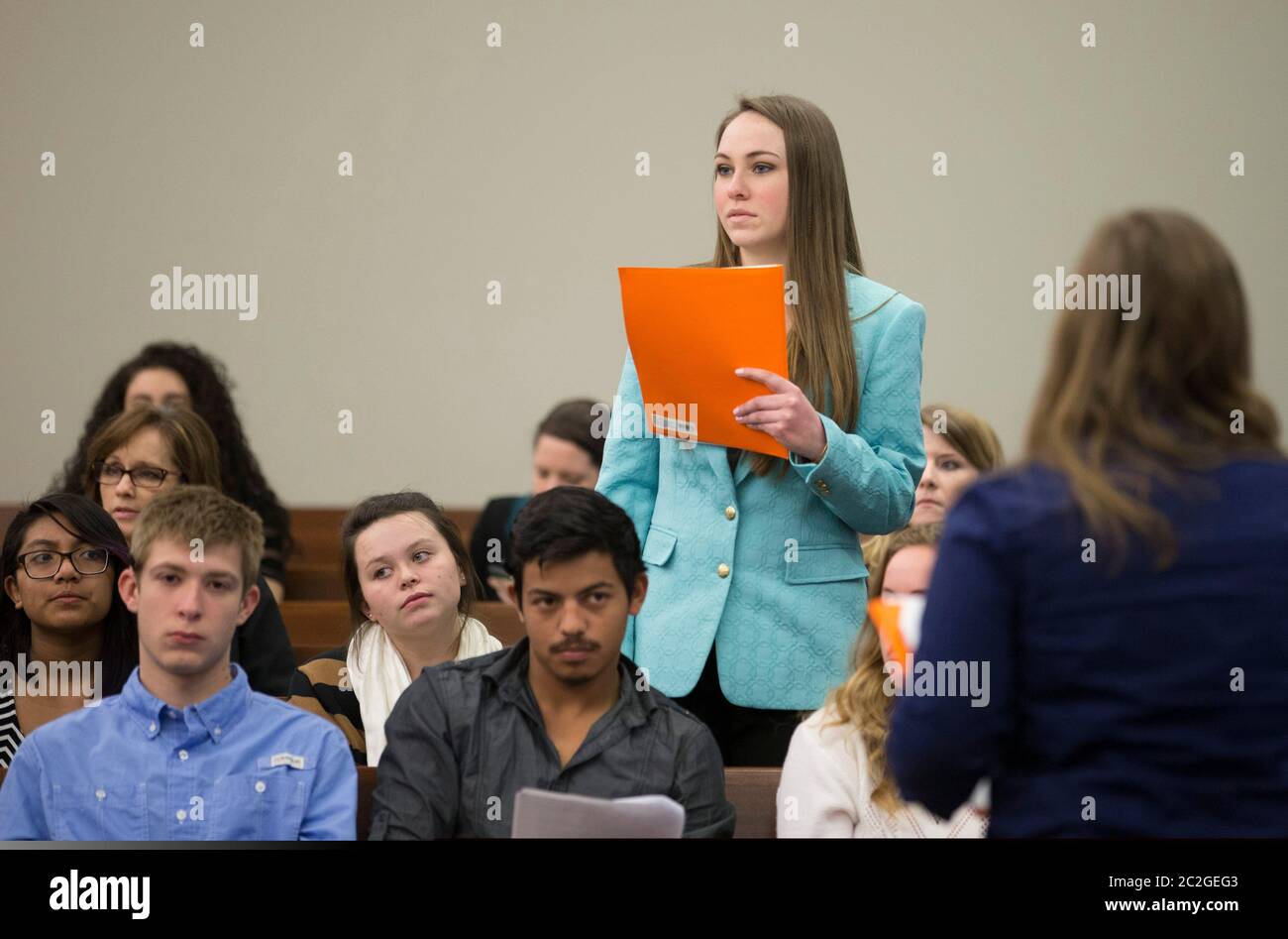 San Marcos, Texas USA, February 27, 2016: Dripping Springs High School student stands to make a statement during a mock trial in a county courtroom that highlights the dangers of dating abuse and unhealthy relationships. The two-hour trial dramatized legal action related to a toxic relationship between a young unmarried couple. ©Bob Daemmrich Stock Photo