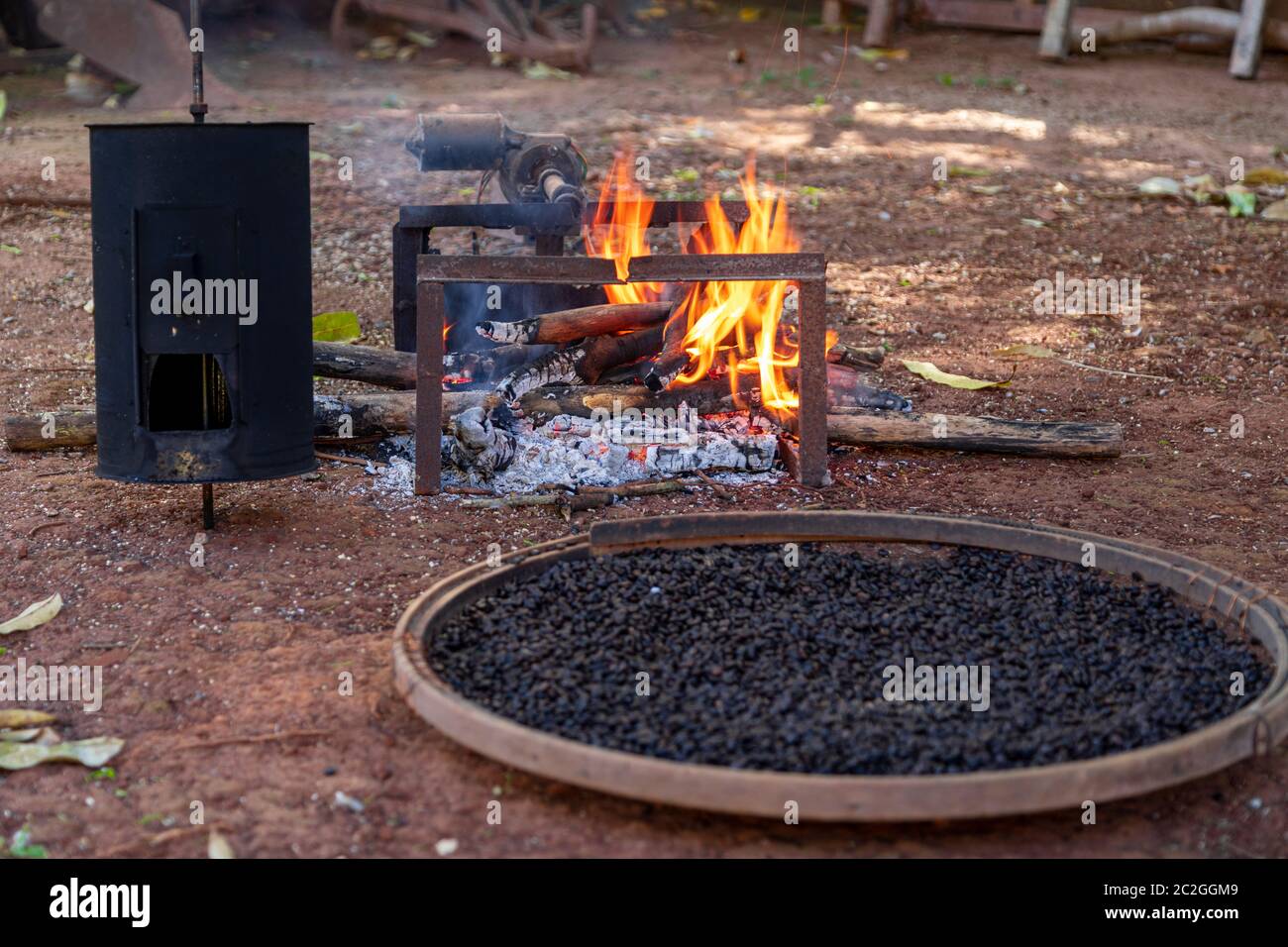 roasting coffee the old farm way, manual roaster, wood fire Stock Photo Alamy