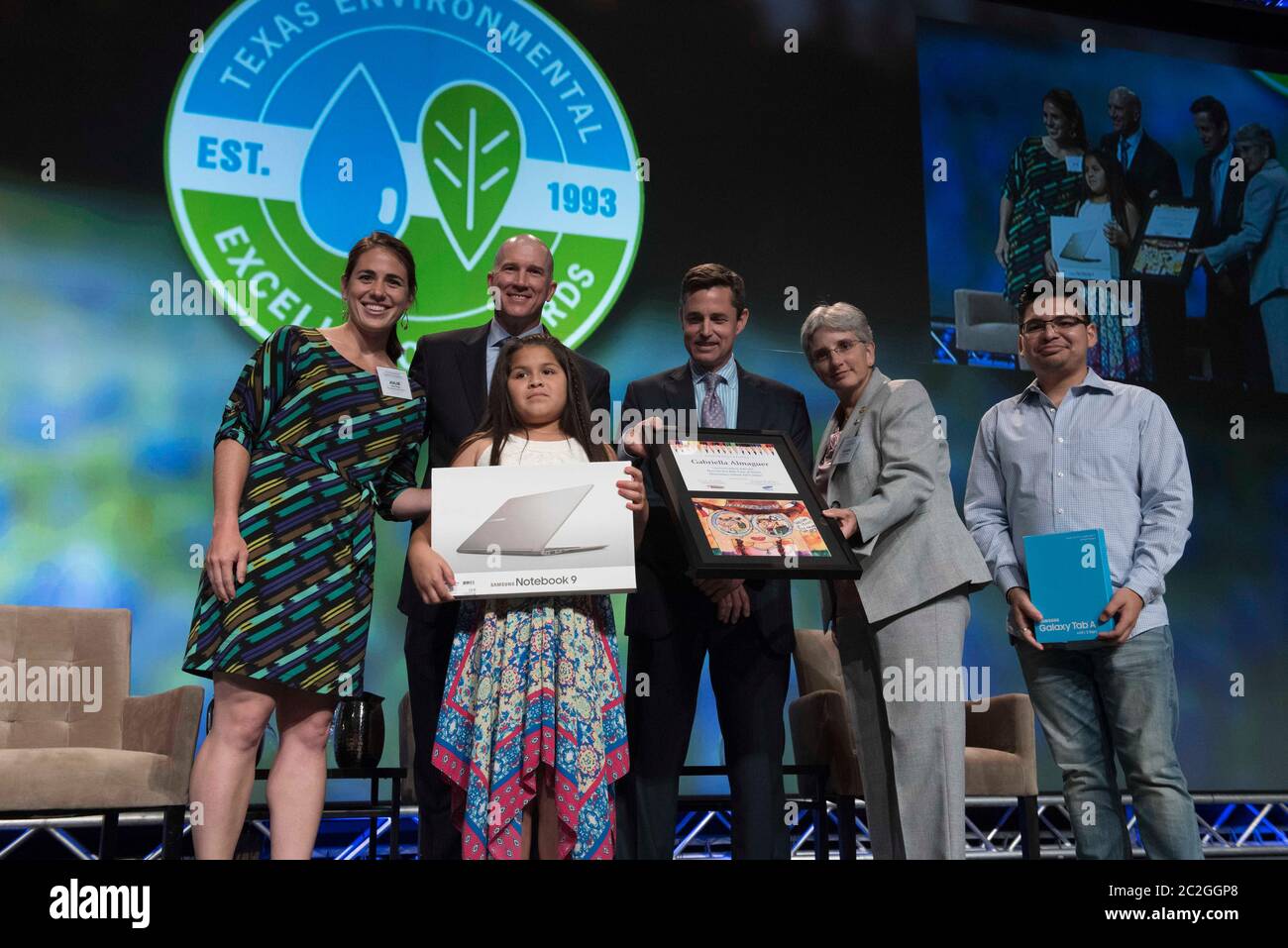 Austin Texas USA, May 4, 2016: Young award winner poses with her award onstage with members of the Texas Commission on Environmental Quality (TCEQ) during the TCEQ's annual Environmental Excellence Awards dinner at the Austin Convention Center.  ©Bob Daemmrich Stock Photo