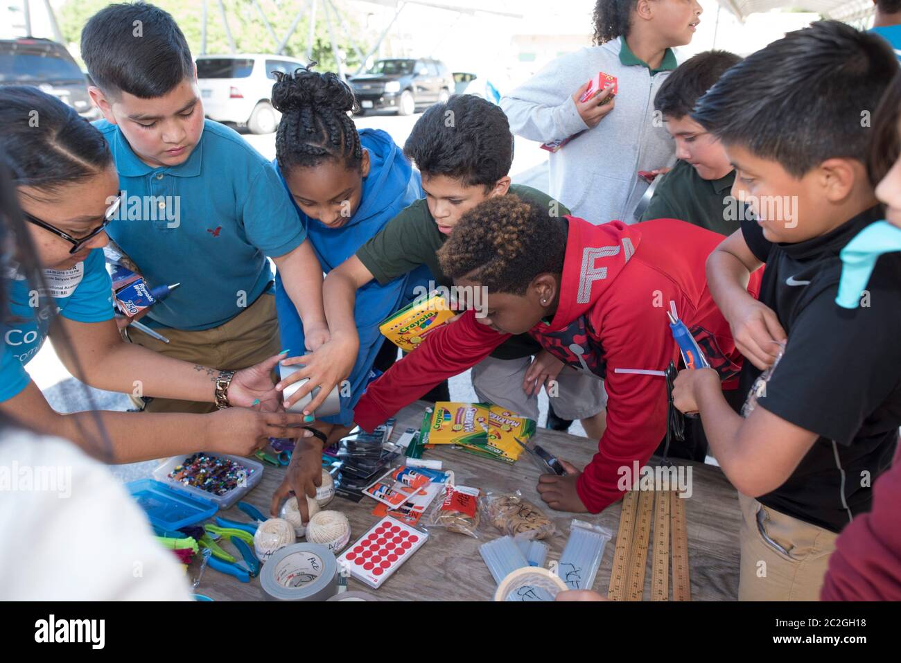 Austin Texas USA, April 20 2016: Students at Cedars International Academy, competing in the Earth Day Cardboard Challenge program at Cedars International Academy, design and build a science display out of cardboard and other simple recycled products. The event was held on Earth Day. ©Bob Daemmrich Stock Photo