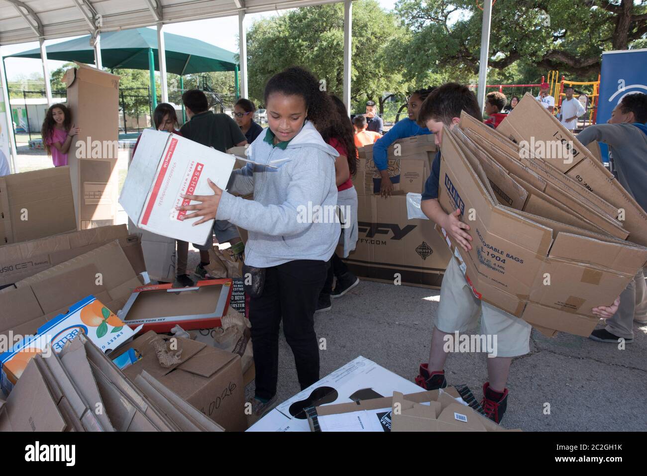 Austin Texas USA, April 20 2016: Students at Cedars International Academy, competing in the Earth Day Cardboard Challenge program at Cedars International Academy, design and build a science display out of cardboard and other simple recycled products. The event was held on Earth Day. ©Bob Daemmrich Stock Photo