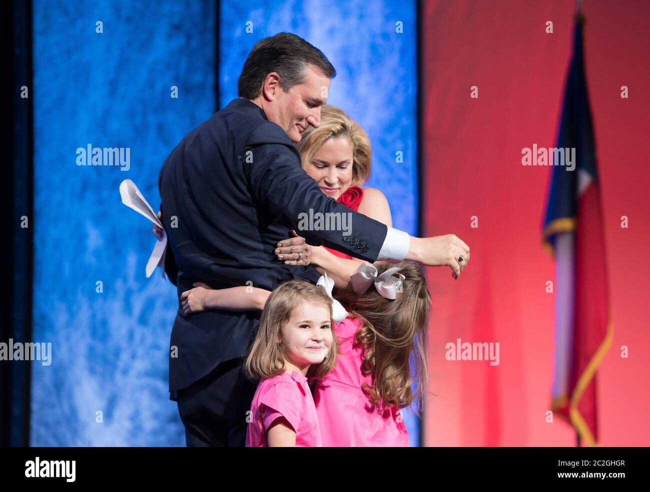 Dallas Texas USA, May 14 2016: U.S. Senator Ted Cruz of Texas hugs his wife and young daughters as they join him onstage at the Republican Party of Texas Convention. ©Bob Daemmrich Stock Photo