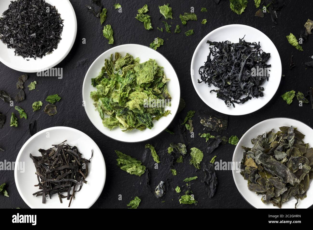 Various dry seaweed, sea vegetables, shot from above on a black