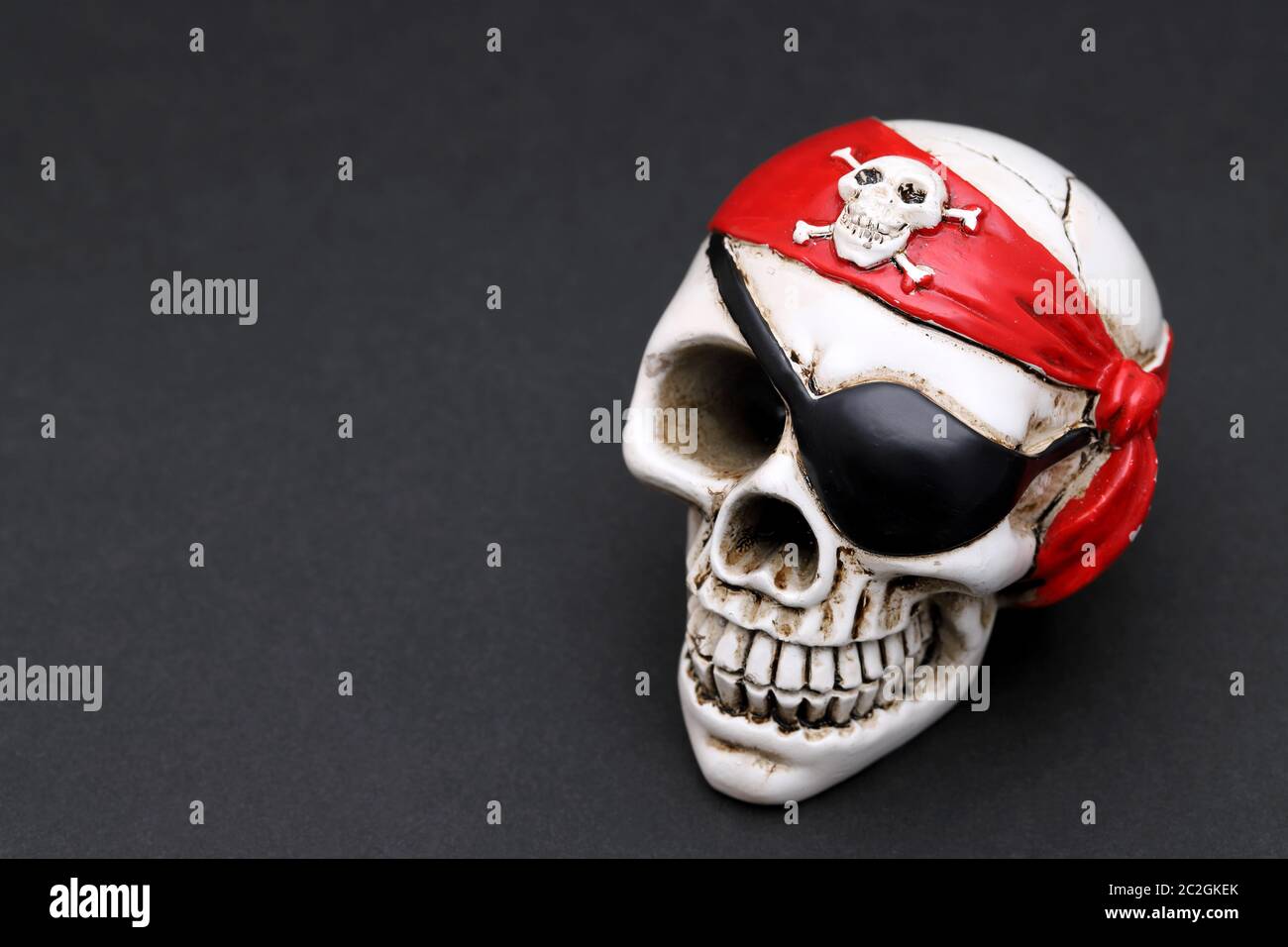 Pirate skull with red head kerchief on dark background Stock Photo