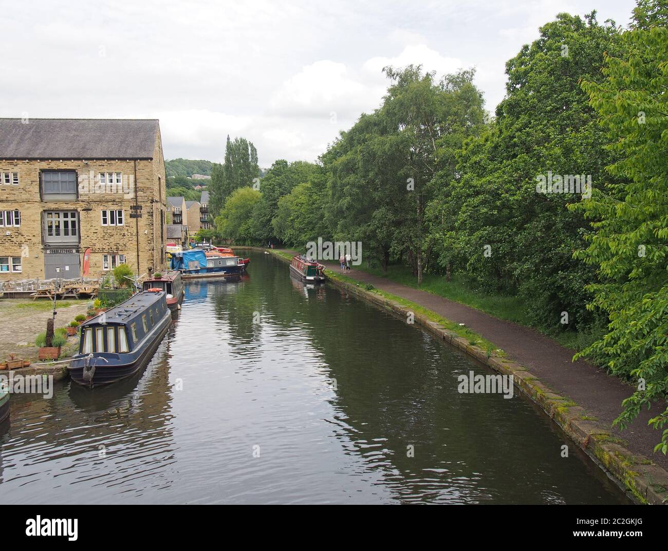 people and boats around the wharf are on the canal in sowerby bridge Stock Photo
