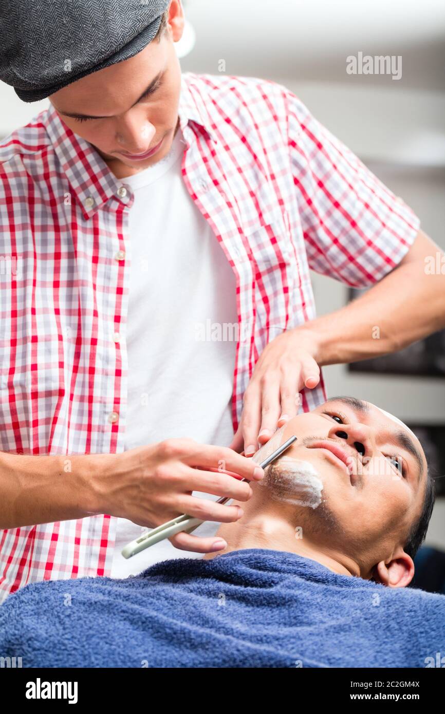 Chinese man shaving customer in hi-res stock photography and images - Alamy