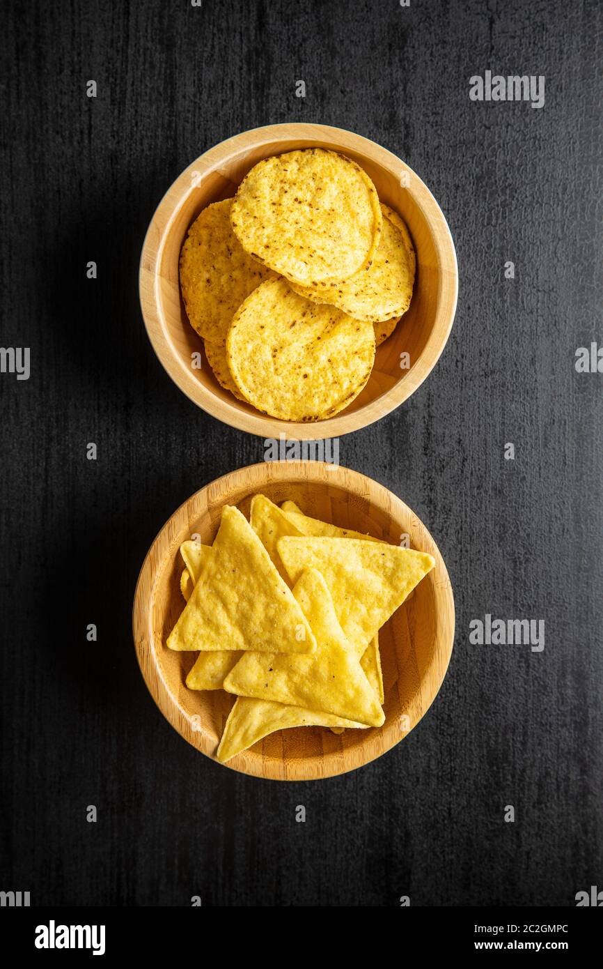 Round and triangular nacho chips. Yellow tortilla chips in bowl on