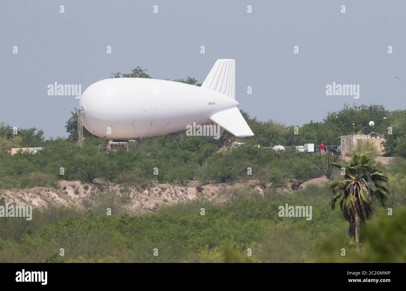 Hidalgo County, Texas April 13, 2018: A TCOM 22M aerostat surveillance balloon is grounded because of high winds as Texas National Guard troops converge on the Texas-Mexico border in south Texas. Texas Gov. Greg Abbott called up almost 1,400 Texas National Guard troops to enhance border security against illegal immigration. ©Bob Daemmrich Stock Photo