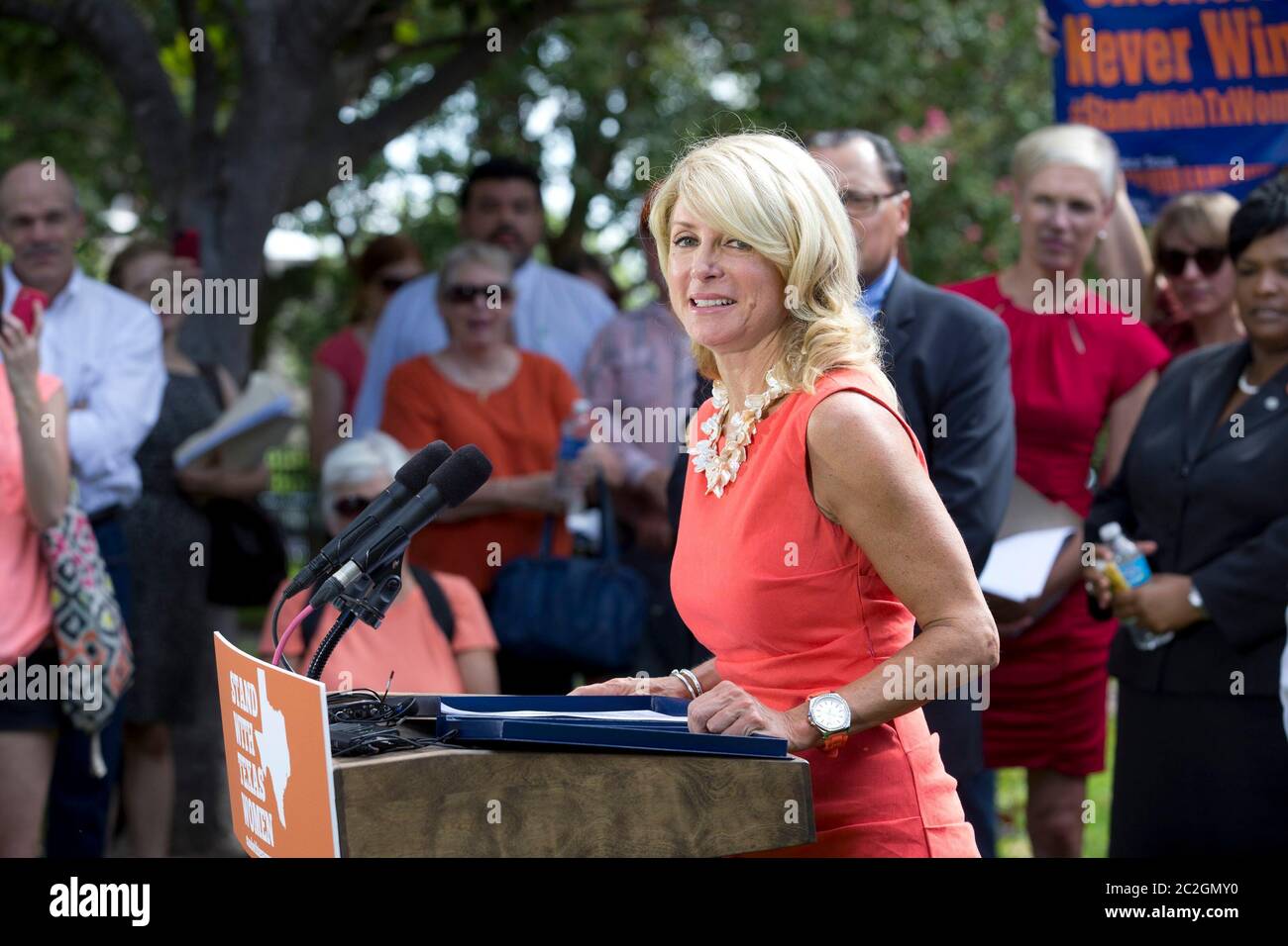 Austin Texas USA, July 2013: State Sen. Wendy Davis, D-Ft. Worth, speaks at a pro-choice rally as activists continue to descend on the Capitol while Texas lawmakers struggle to pass a bill limiting the number of abortion providers by increasing medical standards for clinics to the level of ambulatory surgical centers. Cecille Richards, president of Planned Parenthood, stands behind Davis wearing a red dress. ©Bob Daemmrich Stock Photo