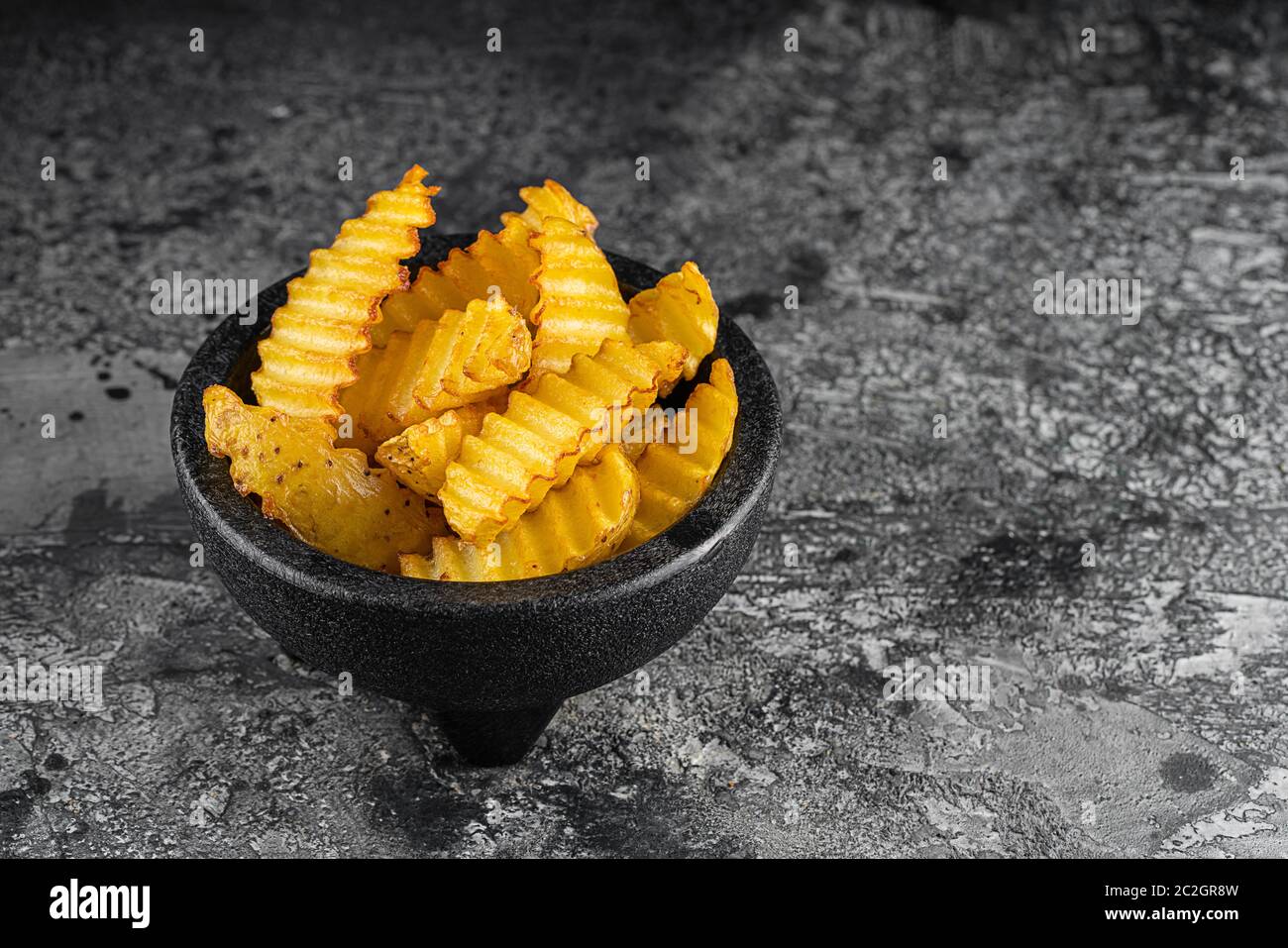 Baked potato fries on wooden table Stock Photo