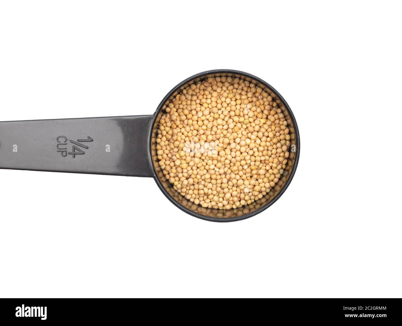 Mustard seeds in measuring spoon on white background Stock Photo