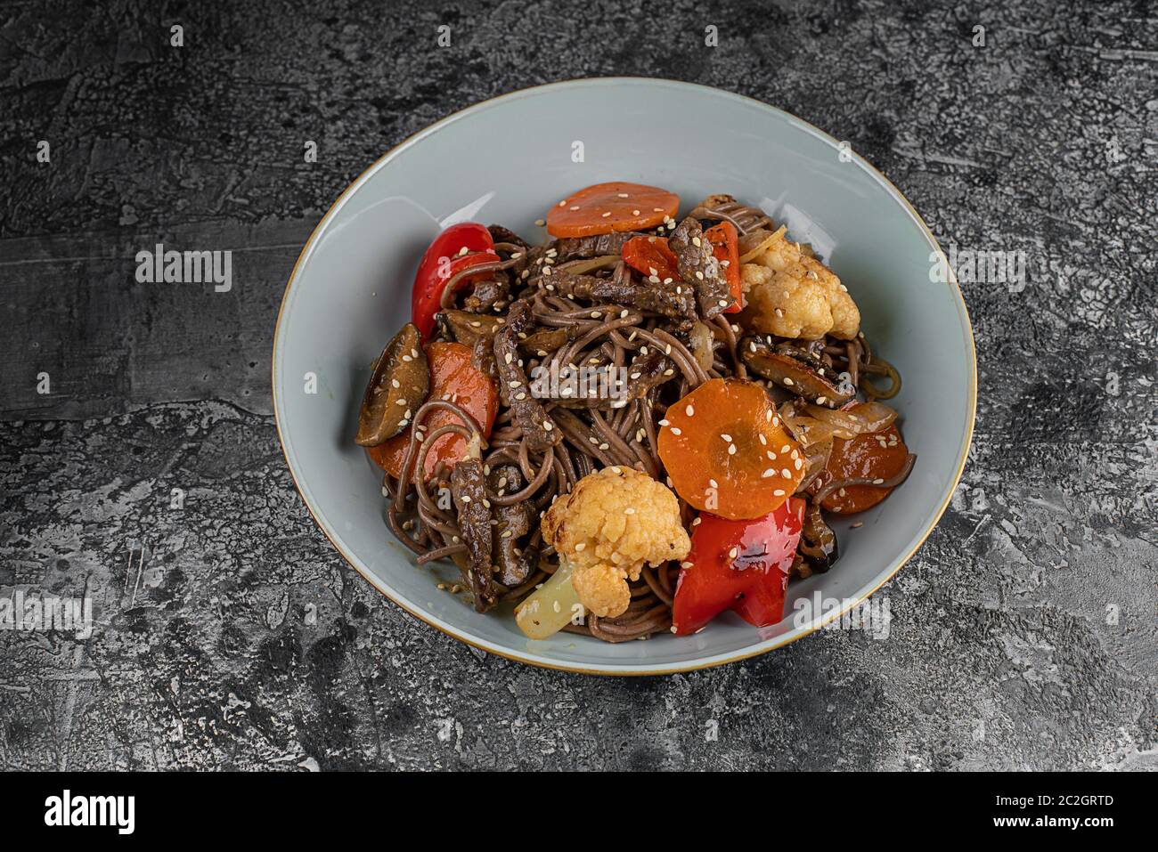 Soba noodles with beef, carrots, onions and sweet peppers. Top view Stock Photo