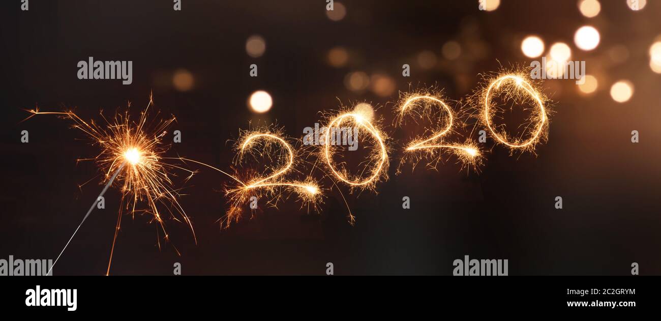 Happy new year 2020 background with sparkler and bokeh Stock Photo