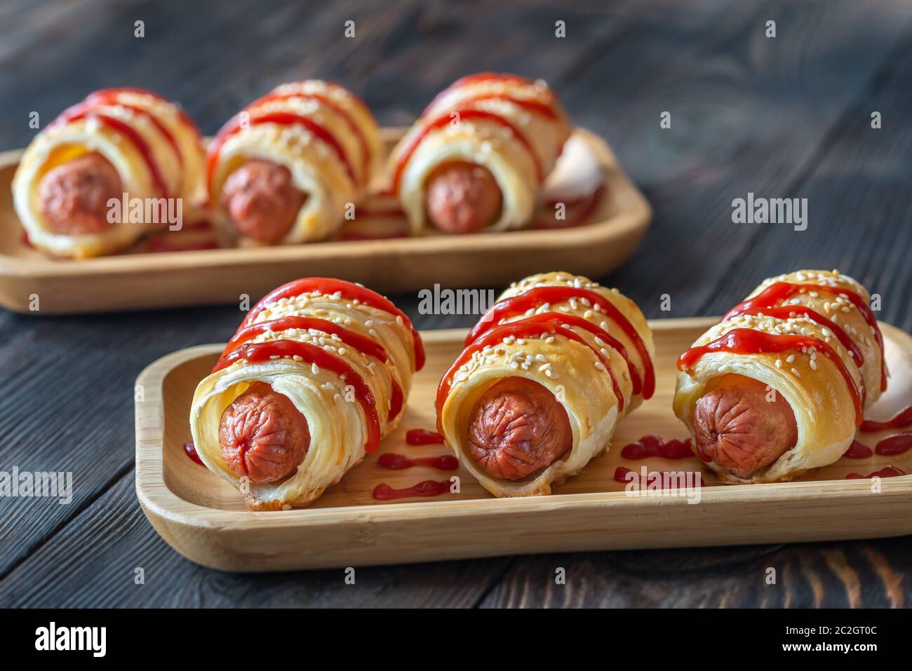 Sausage rolls on the wooden tray: top view Stock Photo