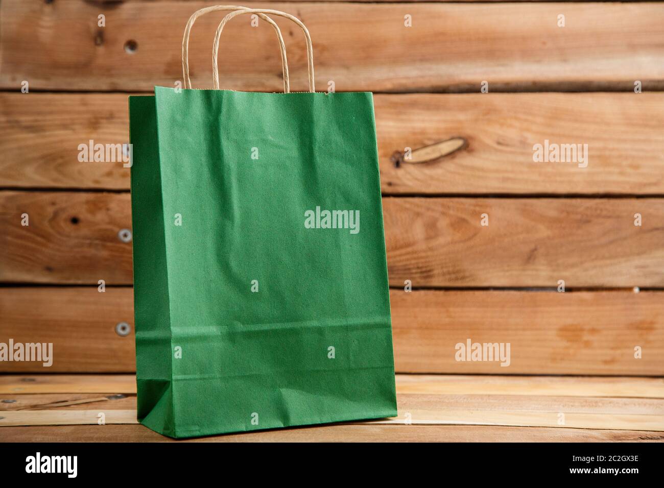 biodegradable environmentally friendly cardboard bag on wooden background Stock Photo