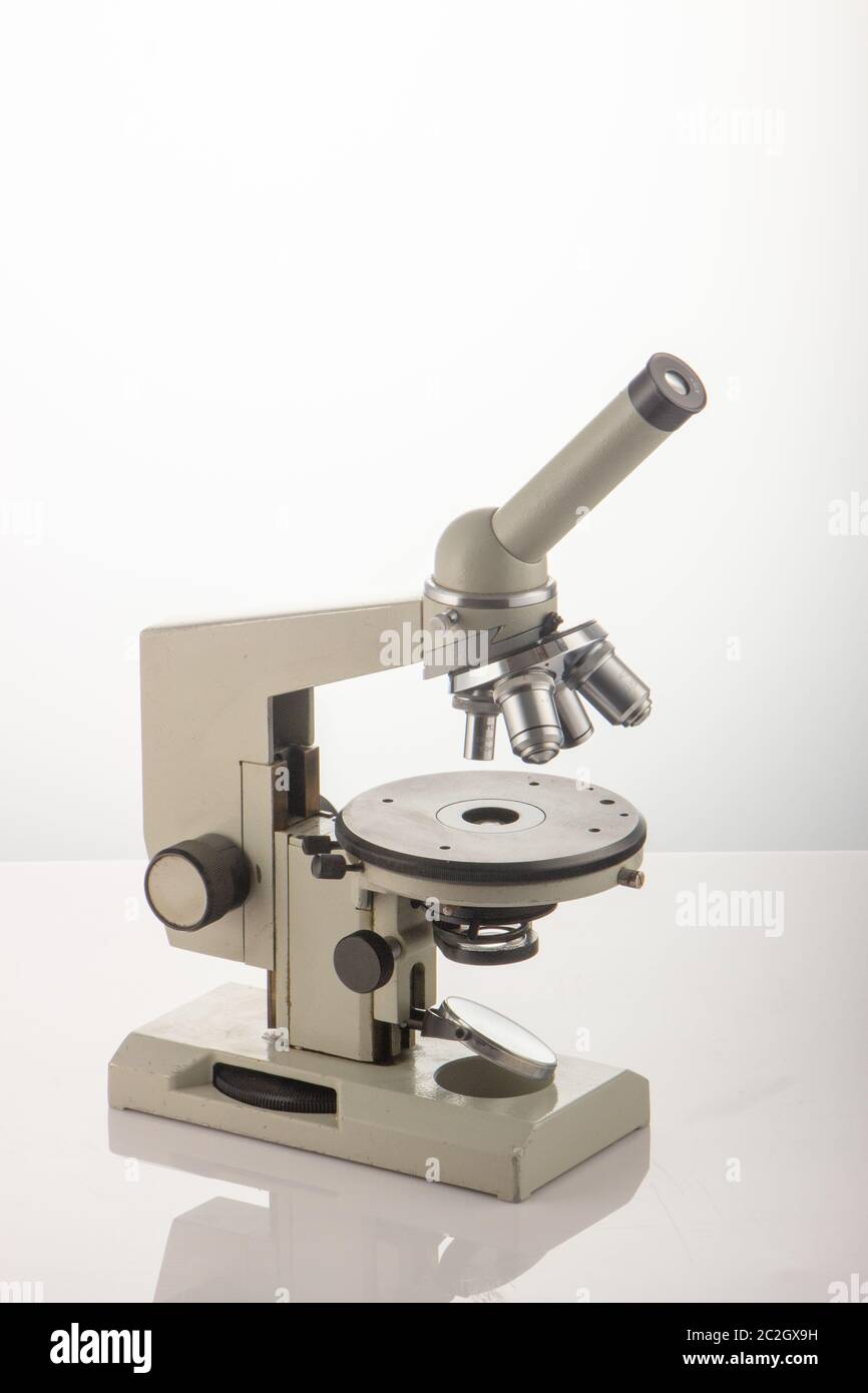 White microscope on table over white background close up Stock Photo