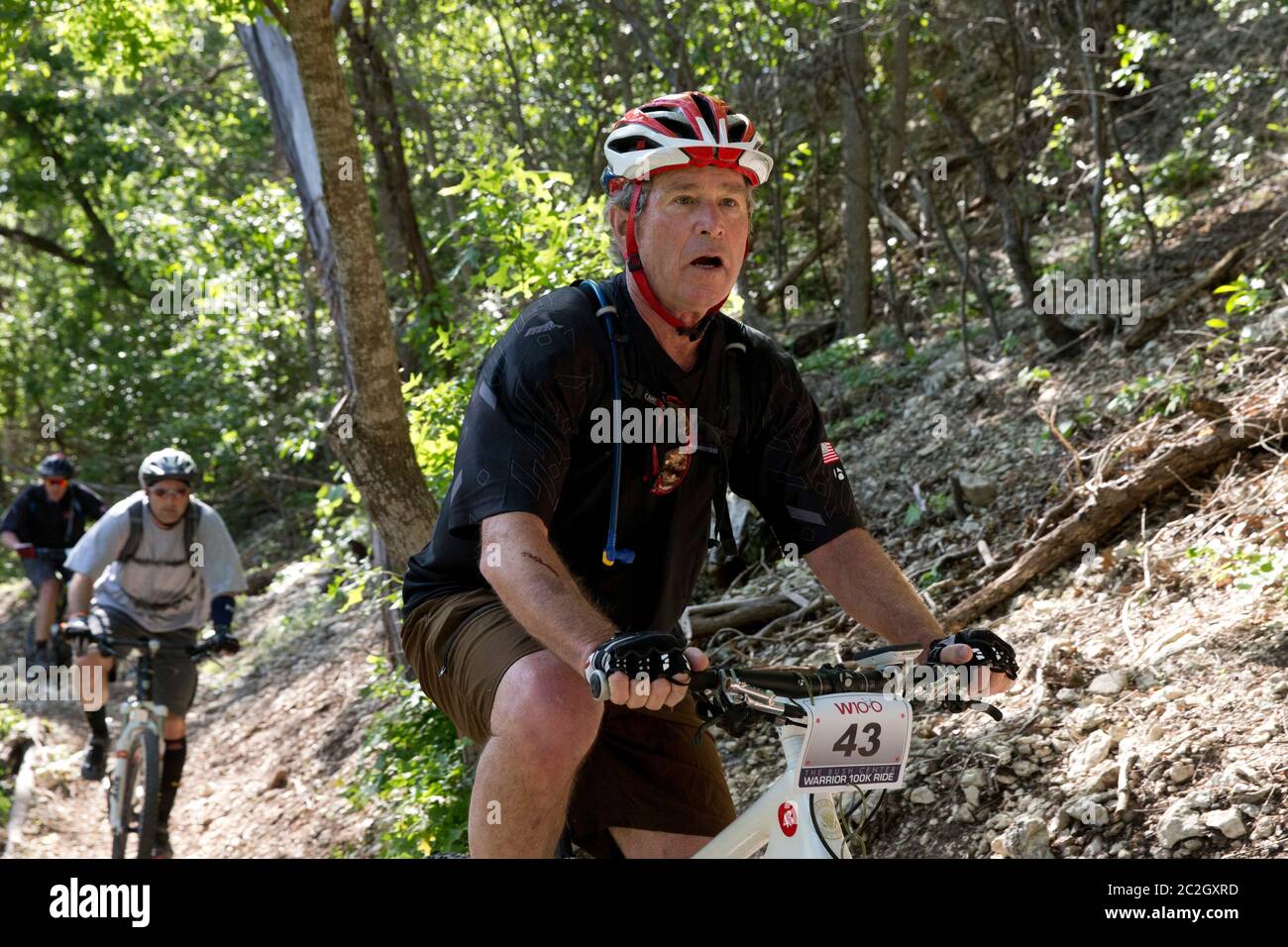 Crawford Texas USA, May 2 2014: Former President George W. Bush leads a pack of bicycle riders through his Prairie Chapel Ranch outside Crawford in the fourth annual Wounded Warrior 100K. The three-day event featured 17 invited U.S. soldiers injured in recent combat in Iraq and Afghanistan.   ©Bob Daemmrich Stock Photo