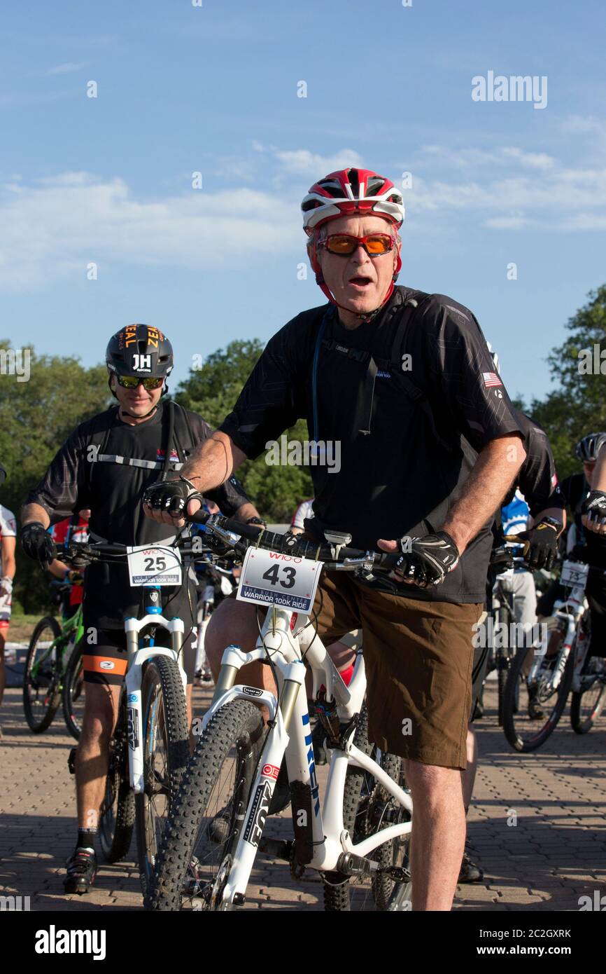 Crawford Texas USA, May 2 2014: Former President George W. Bush leads a pack of bicycle riders through his Prairie Chapel Ranch outside Crawford in the fourth annual Wounded Warrior 100K. The three-day event featured 17 invited U.S. soldiers injured in recent combat in Iraq and Afghanistan.   ©Bob Daemmrich Stock Photo