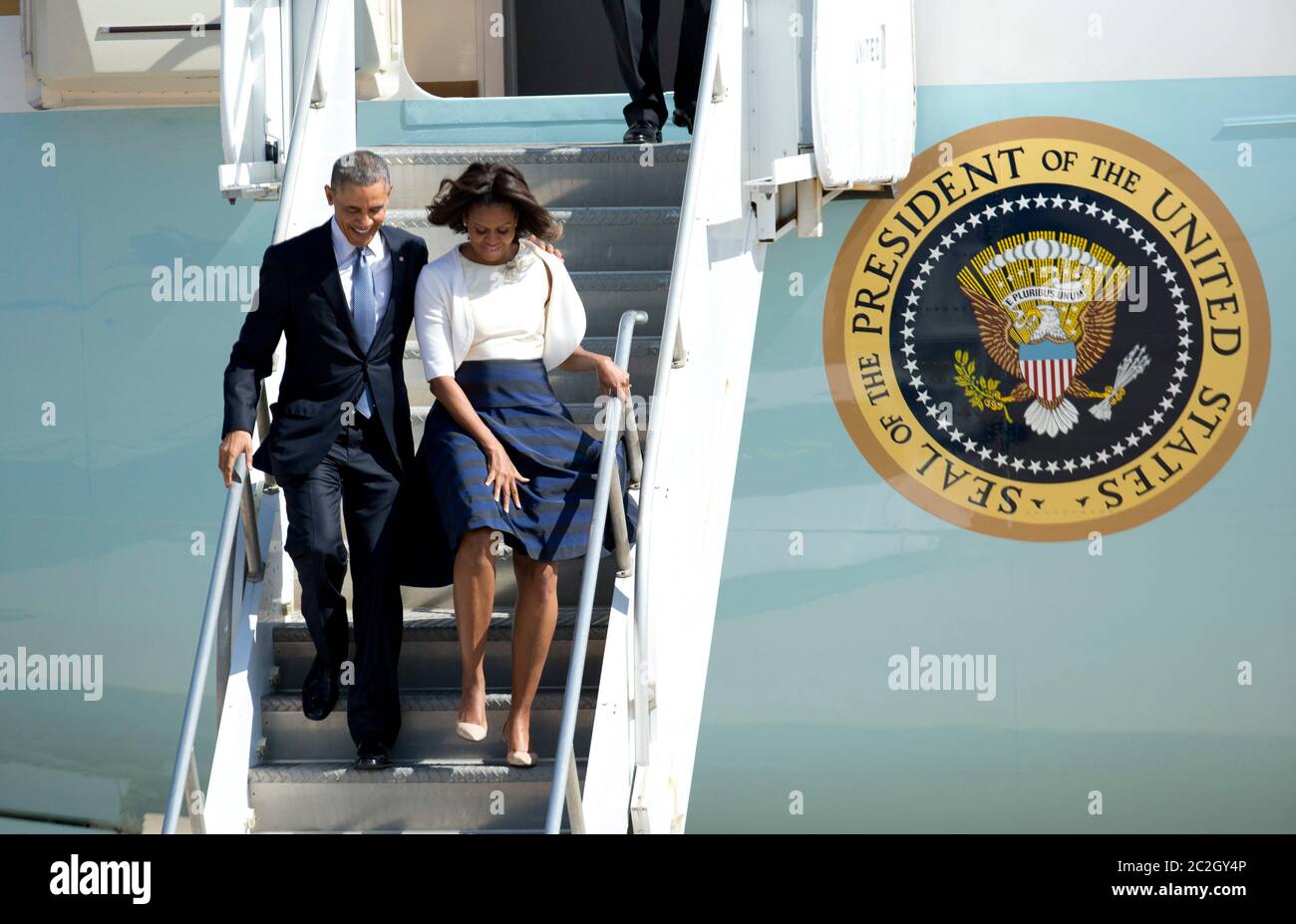 Austin Texas USA, April 10 2014: President Barack Obama and First Lady Michelle Obama arrive on Air Force One at a windy Austin airport for an appearance at the LBJ Civil Rights Summit at the LBJ Library. Obama is one of four living presidents invited to speak at the conference.   ©Bob Daemmrich Stock Photo