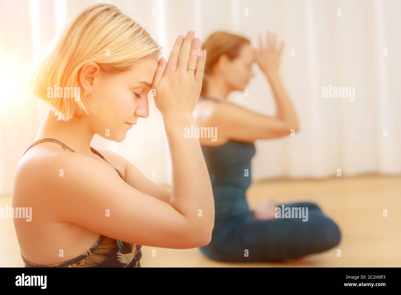 Yoga class hands on the forehead Stock Photo