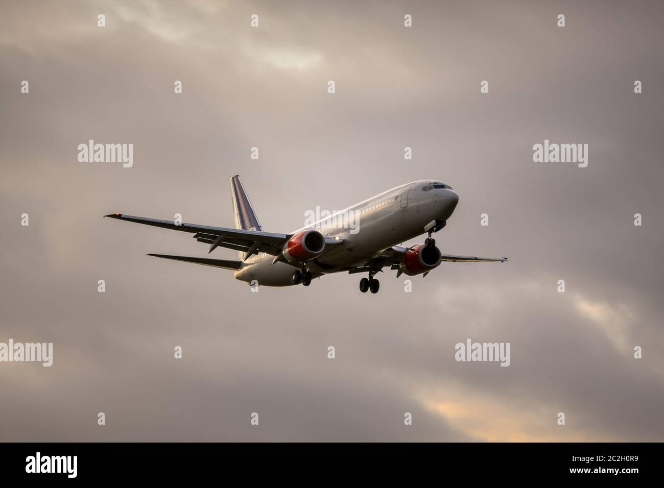 air plane in sunset sky Stock Photo
