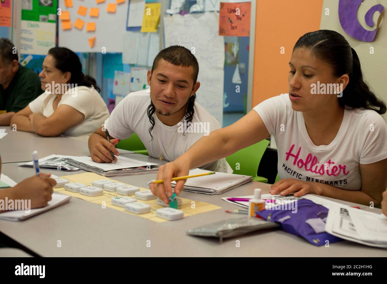 Austin Texas USA, July 2014: Students use word-game tiles while attending a free English as a Second Language (ESL) classes for non-native English speakers, a program of Foundation Communities, an Austin-based social service agency that provides housing and education programs for low-income households.   ©Bob Daemmrich Stock Photo