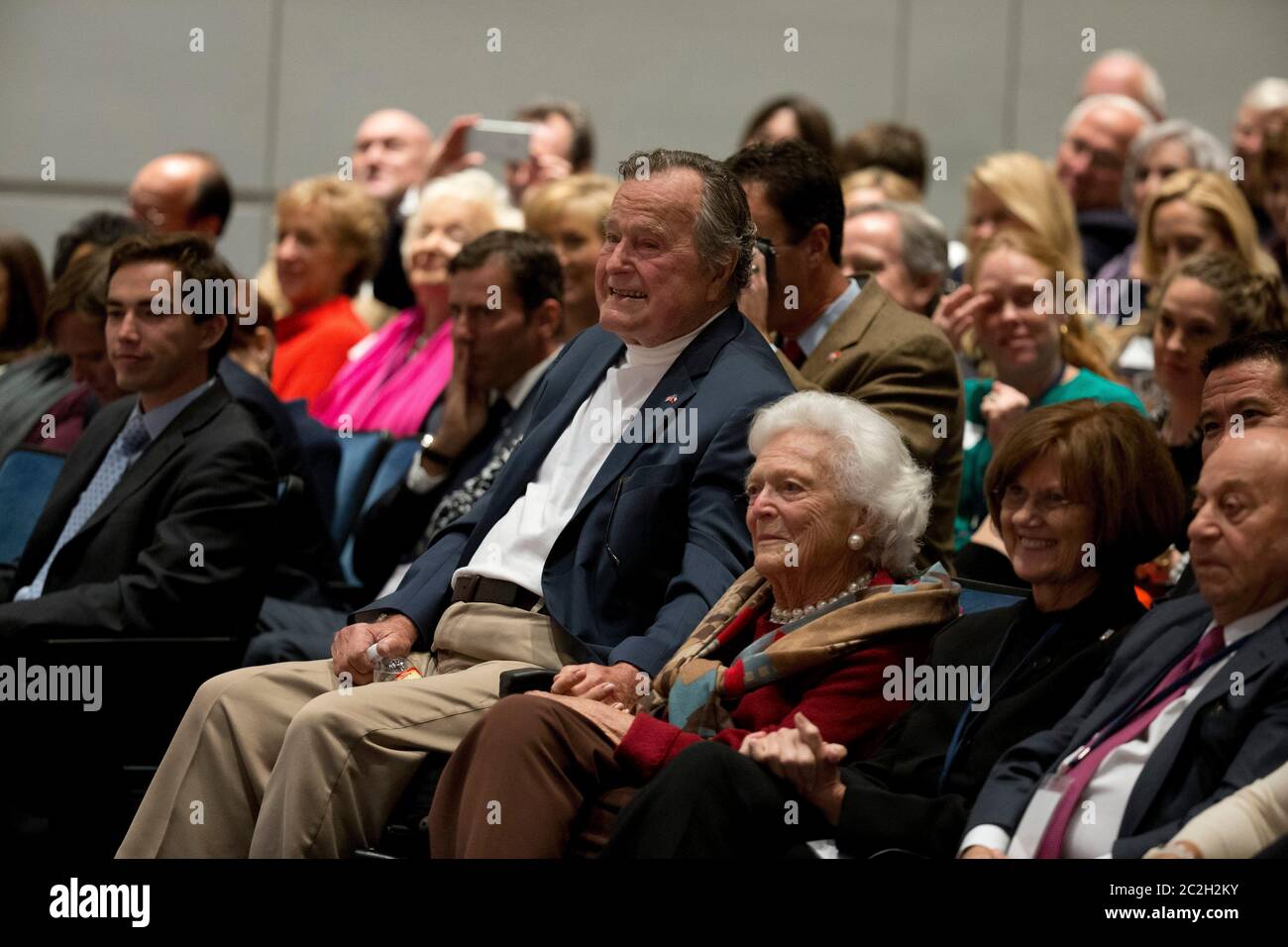 College Station, Texas USA, November 11 2014: Former U.S. President George H. W. Bush listens with his wife, Barbara Bush, as his son former President George W. Bush talks about his new book, '41: A Portrait of My Father'  during a book event at the Bush Library at Texas A&M University.   ©Bob Daemmrich Stock Photo