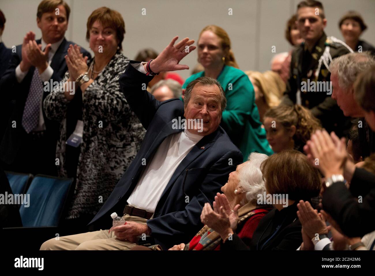 College Station, Texas USA, November 11 2014: Former U.S. President George H. W. Bush waves to the crowd as he and his wife, Barbara Bush, listen to their son, former President George W. Bush, talk about his new book, '41: A Portrait of My Father'  during a book event at the Bush Library at Texas A&M University.   ©Bob Daemmrich Stock Photo