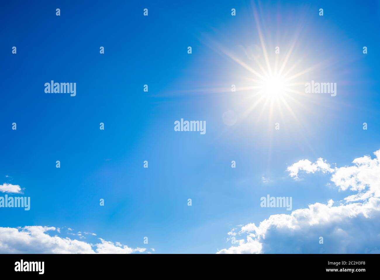 Sunny background, blue sky with white clouds and sun Stock Photo