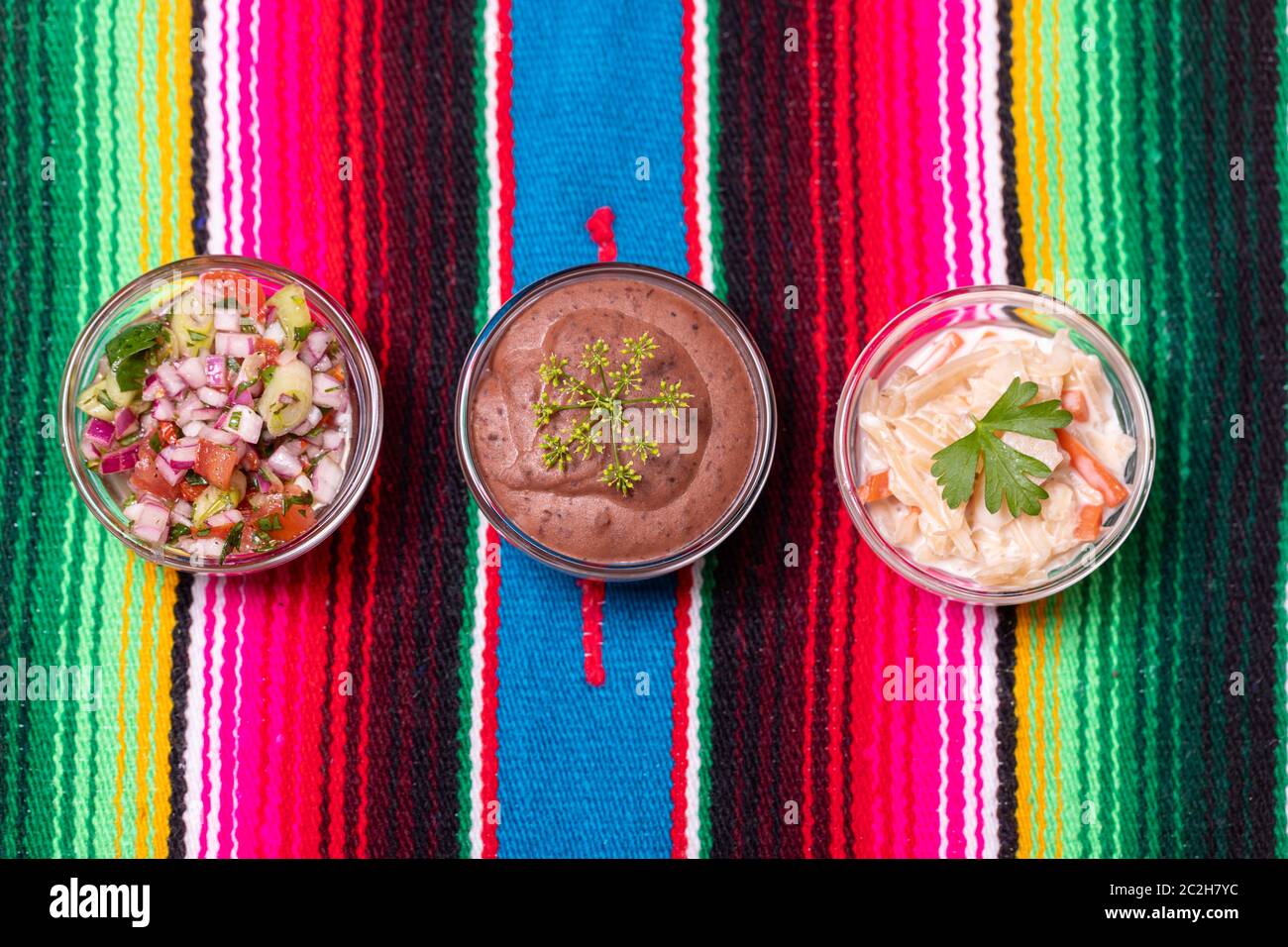 three mexican salsas on colorful woodl cloth Stock Photo - Alamy