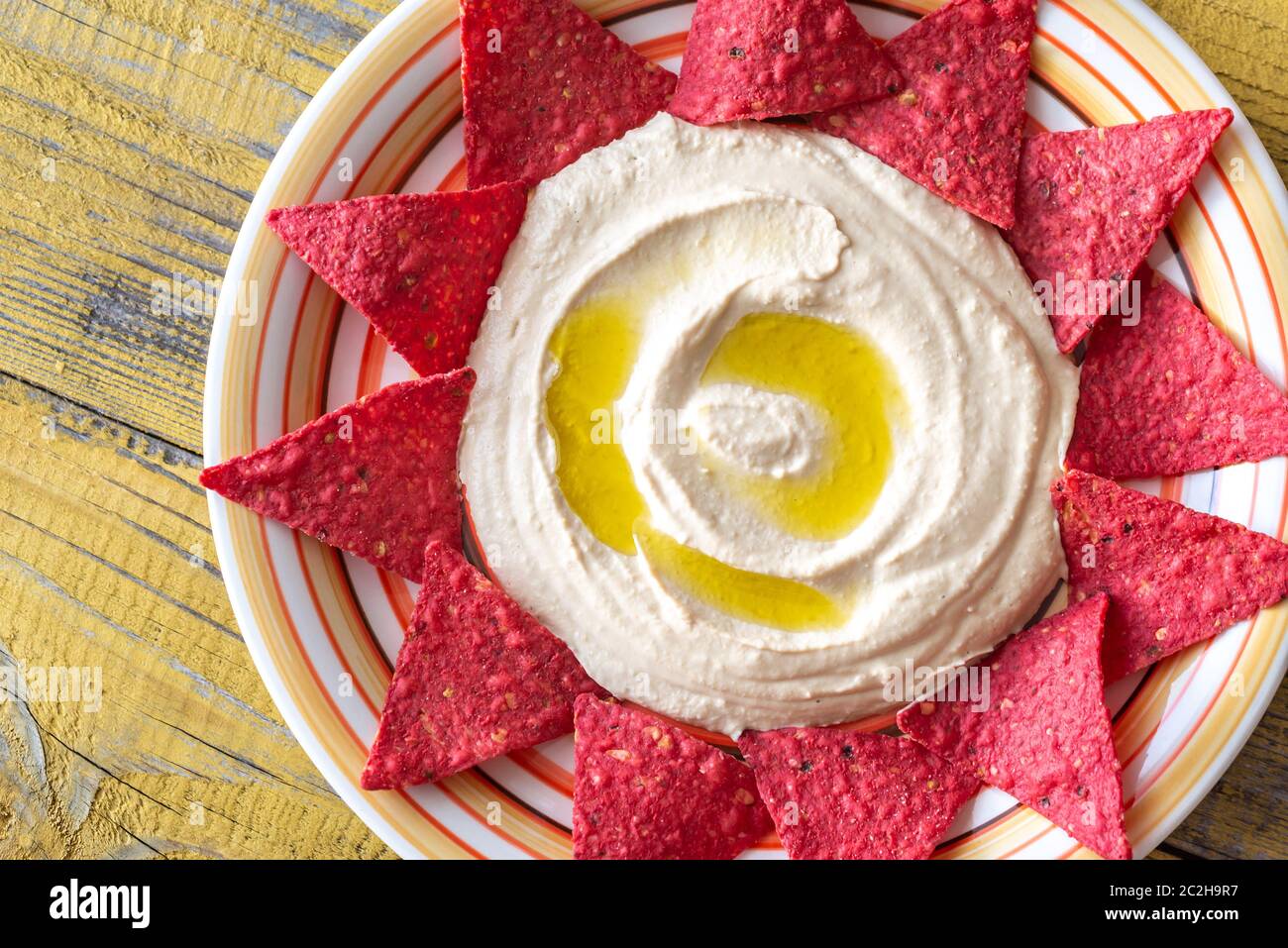Hummus with tortilla chips top view Stock Photo Alamy