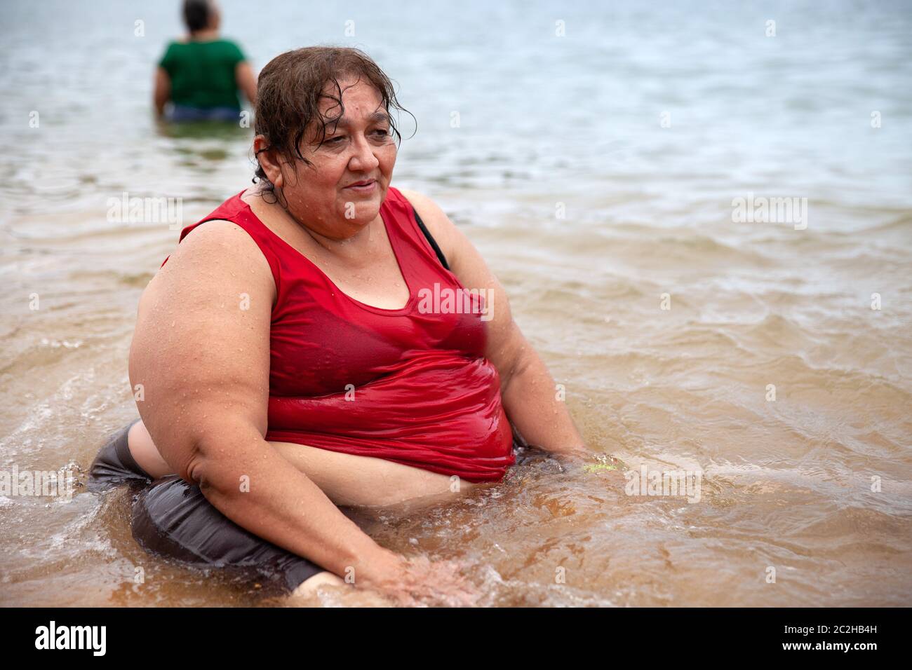 Marbella sits on the beach in Acapulco, Mexico on September 6, 2013. Marbella Aguilar Sosa is a 57-year-old Mexican woman with morbid obesity. She suf Stock Photo