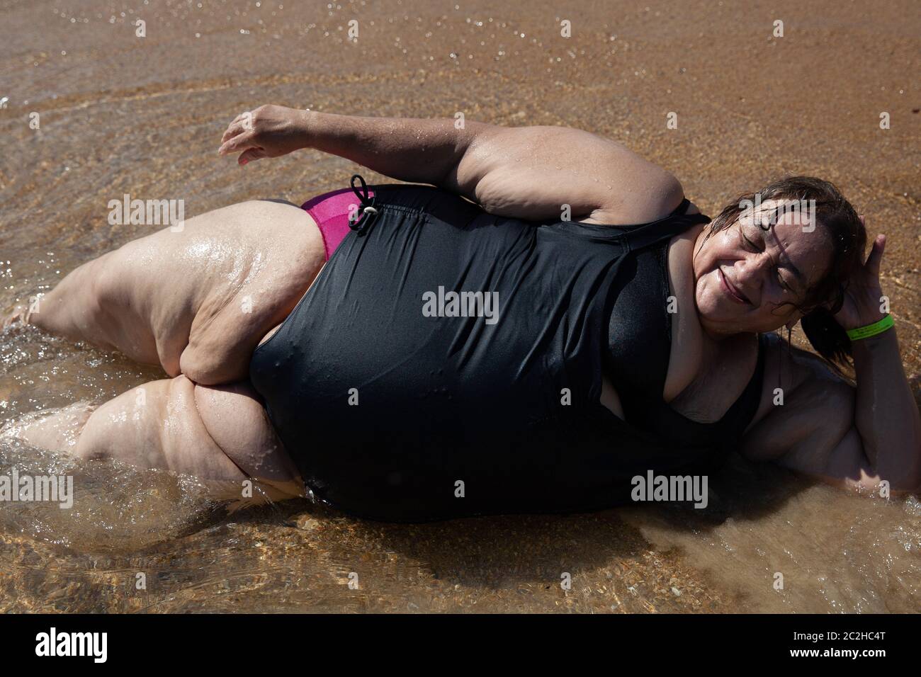Marbella lies on the beach in Acapulco, Mexico on September 7, 2013. Marbella Aguilar Sosa is a 57-year-old Mexican woman with morbid obesity. She suf Stock Photo