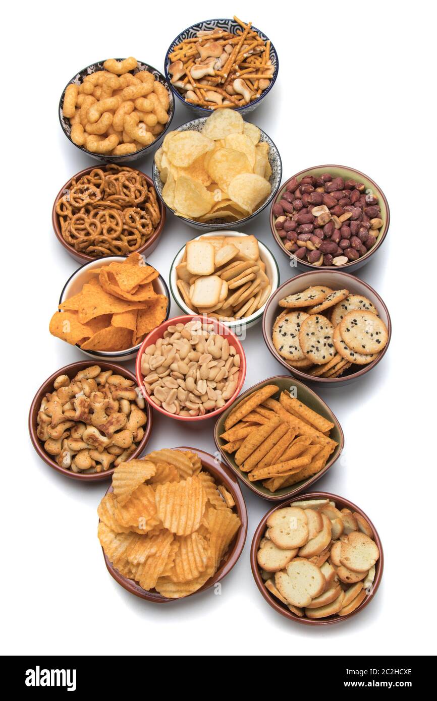 Pretzels, potato chips, crackers and other salty snacks isolated on