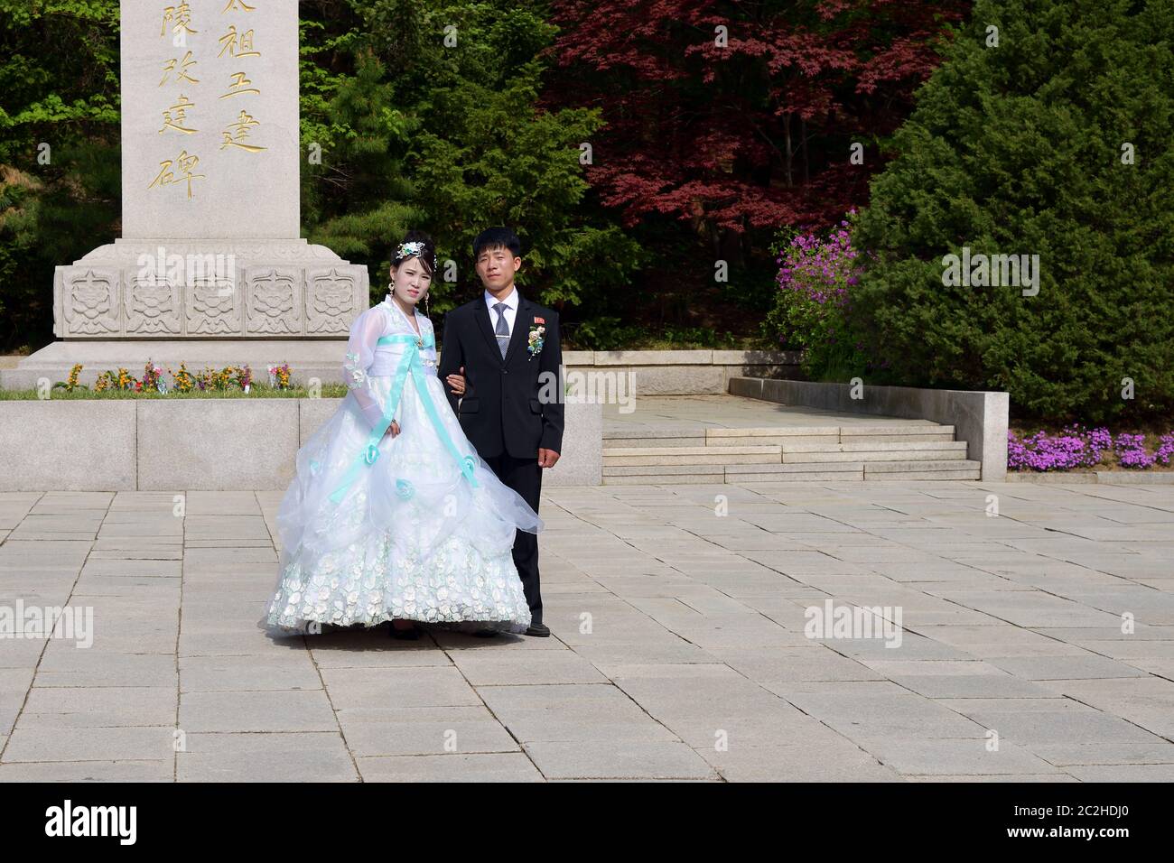 Kaesong, North Korea - May 5, 2019: Young Korean couple in historical place - Tomb of King Wanggon. Newlyweds are photographed against the background Stock Photo