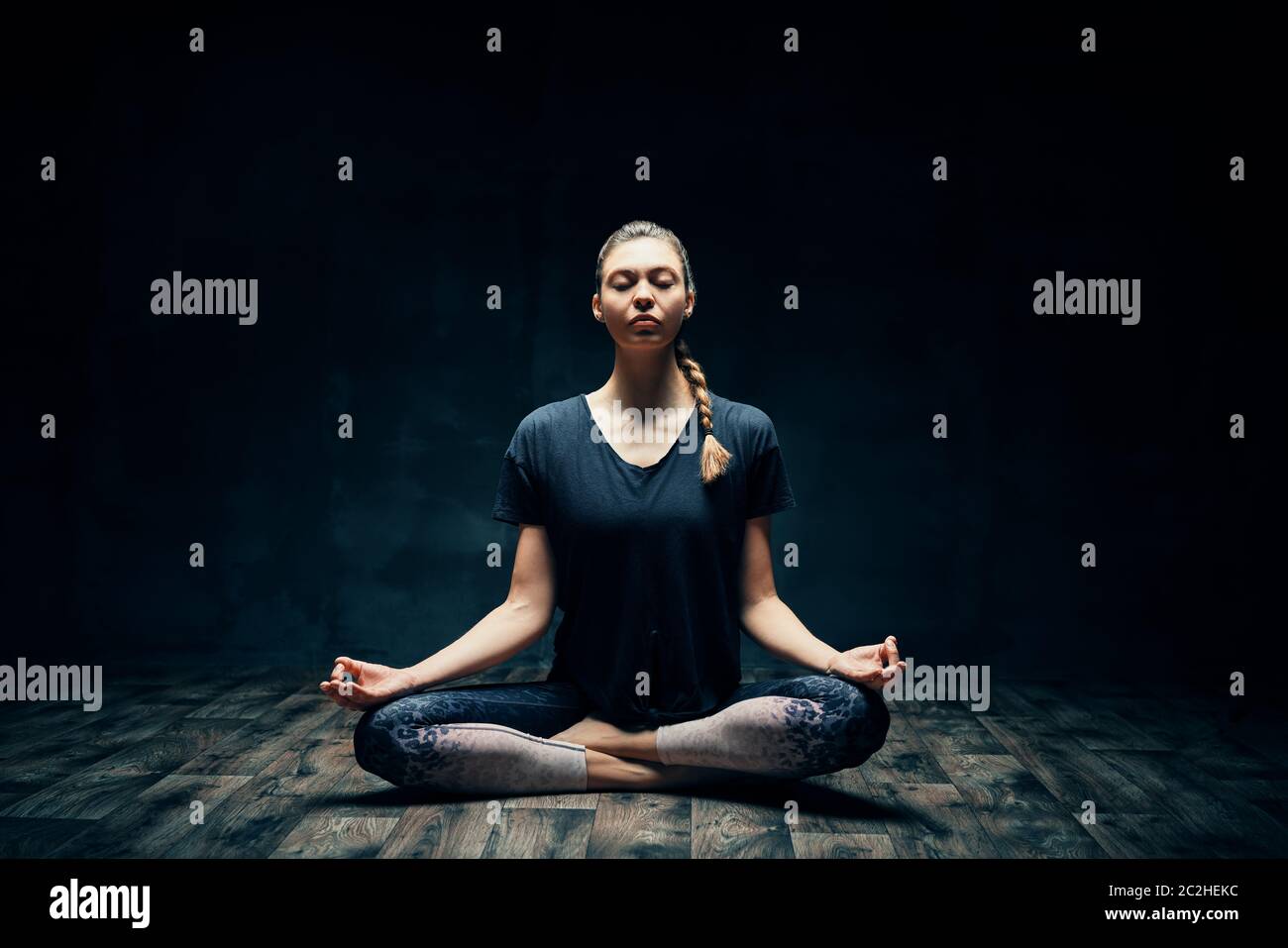 Young attractive woman practicing yoga sitting in lotus pose and ...