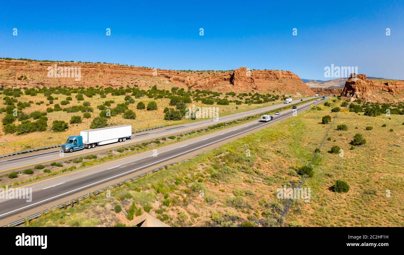 Big Rigs and vacation tavelers drive along the highway in the desert southwest Stock Photo