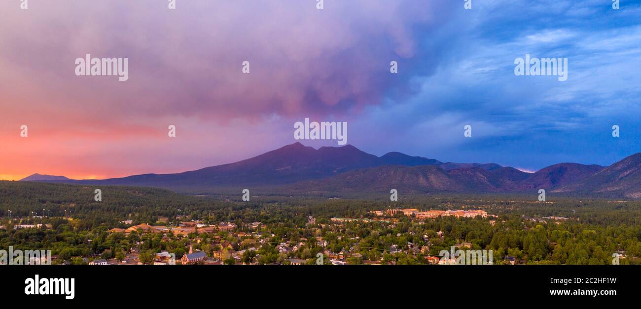 Blue and Orange color swirls around in the clouds at sunset over Flagstaff Arizona Stock Photo