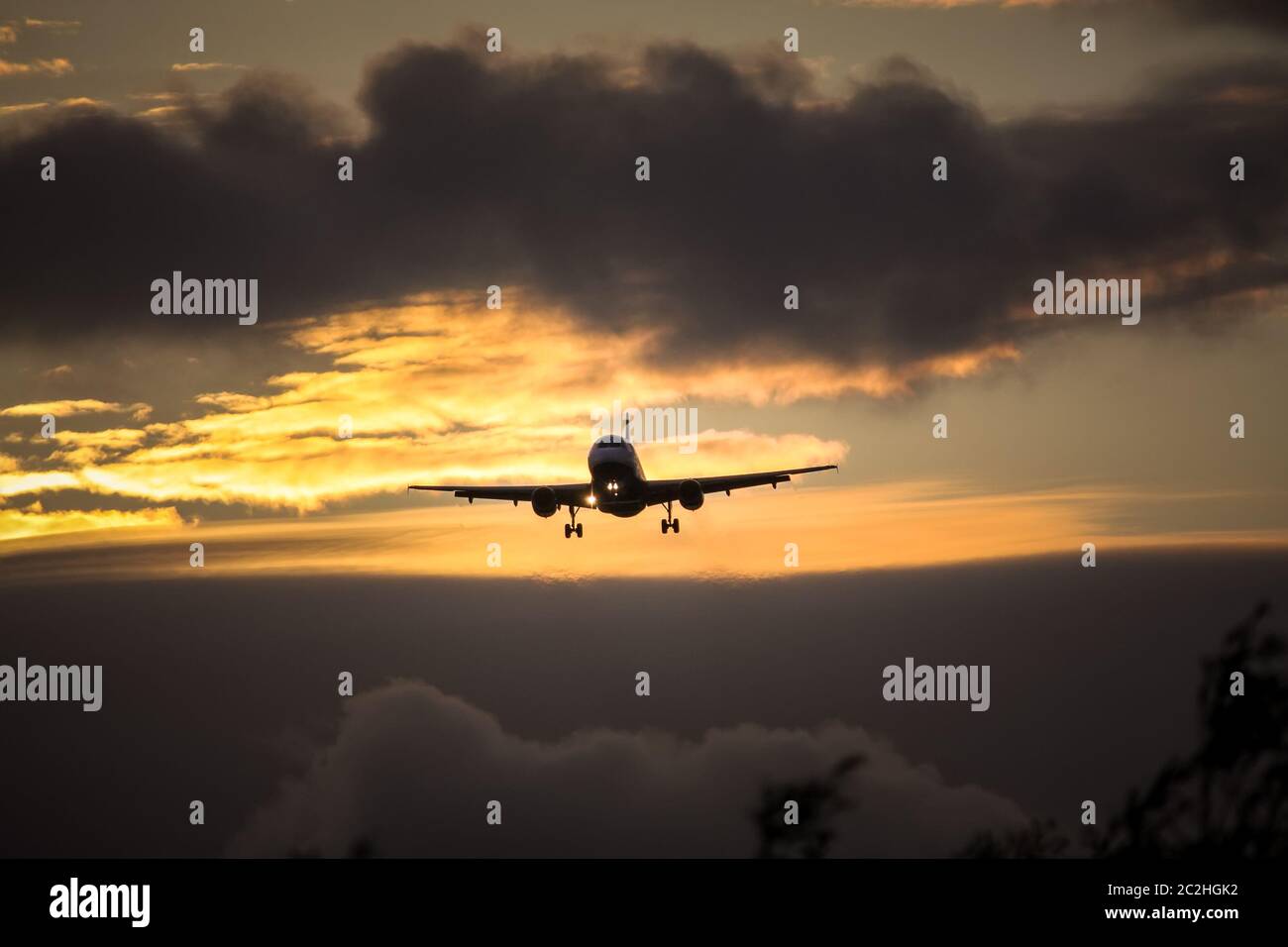 air plane in sunset sky Stock Photo