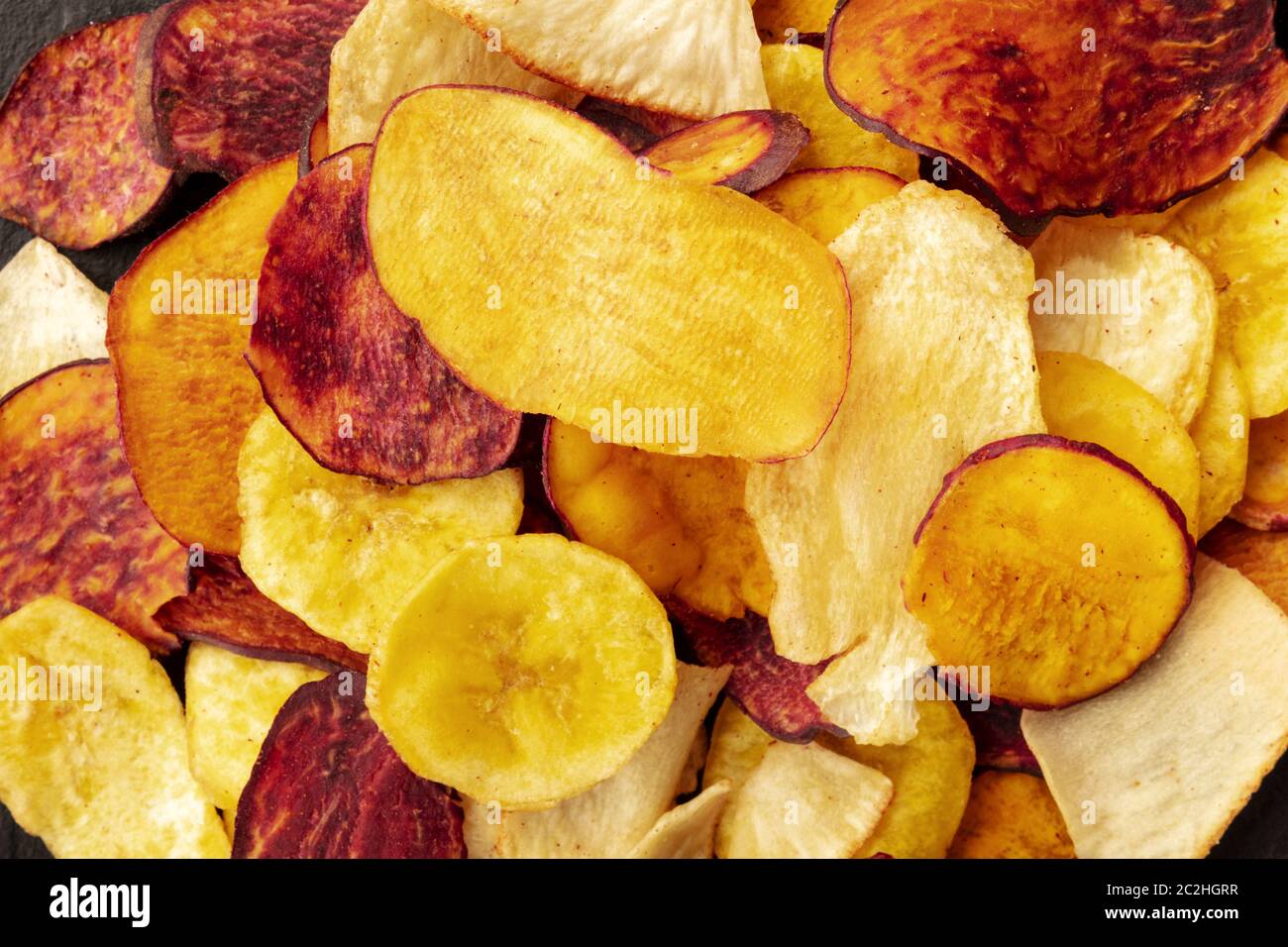 A close-up of dry fruit and vegetable chips, healthy vegan snack, a tasty mix, shot from the top Stock Photo