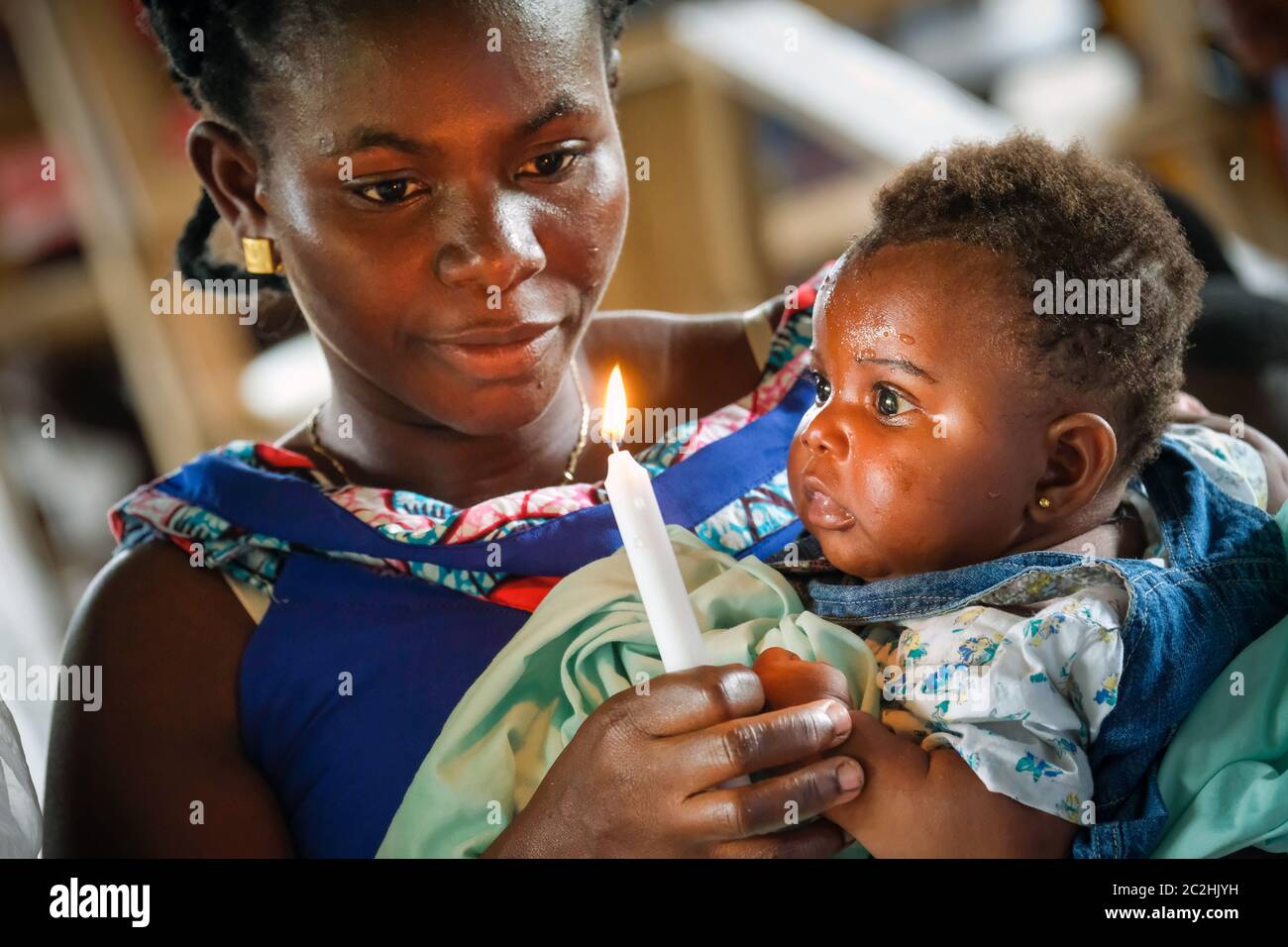 Mother with her baptized girl in a chapel in the stilt village of Nzulezo in Lake Amansura / Ghana Stock Photo