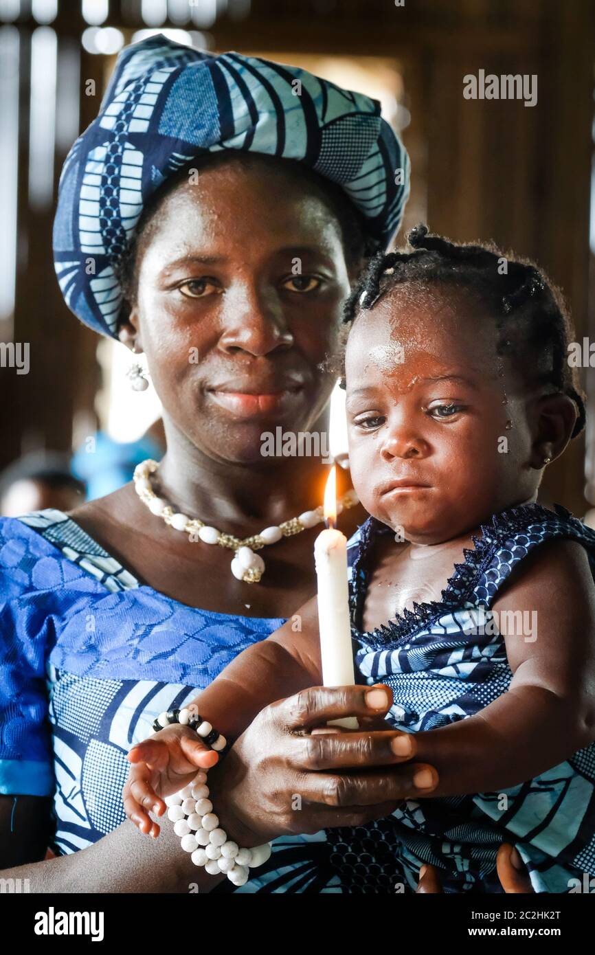 Mother with her baptized girl in a chapel in the stilt village of Nzulezo in Lake Amansura / Ghana Stock Photo