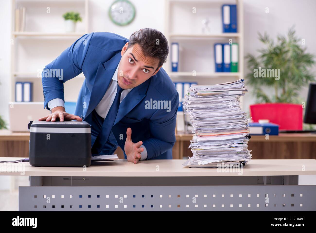 Working Copy Cop Young employee making copies at copying machine Stock Photo - Alamy