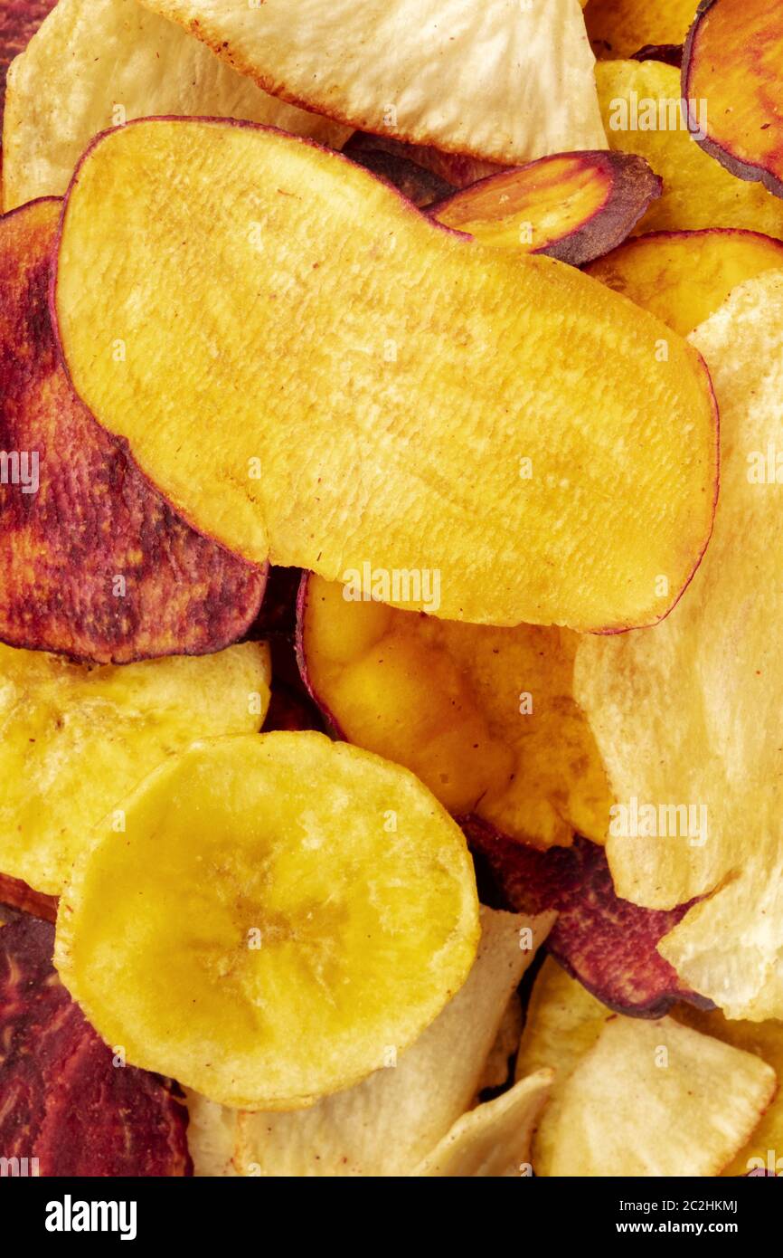A close-up of dry fruit and vegetable chips, healthy vegan snack, a tasty mix, shot from above Stock Photo