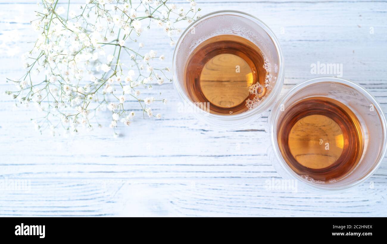 Summer tea on wooden table. Black tea in glass cups. Morning tea in mugs with place for text. Top view background Stock Photo