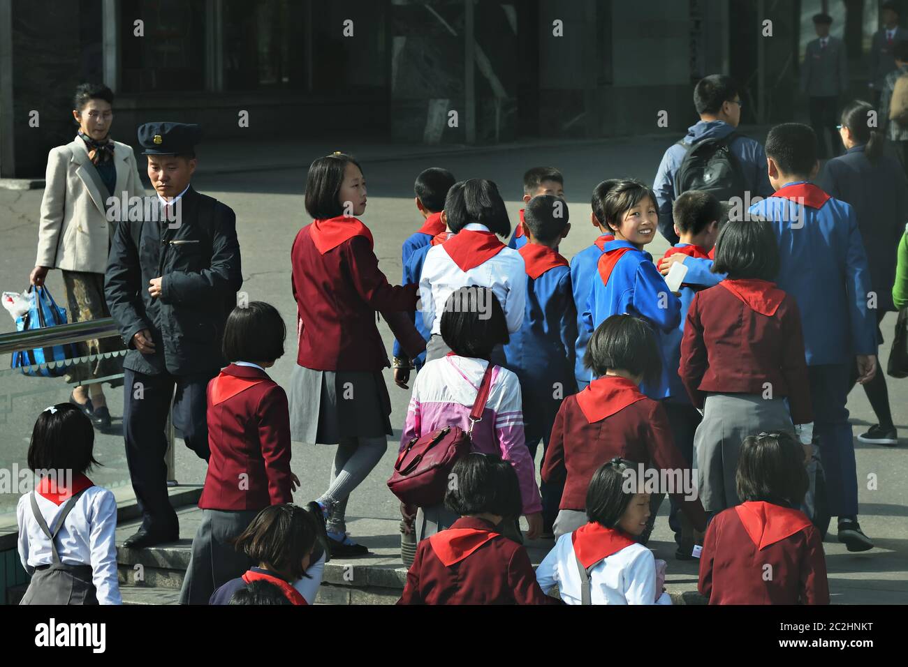 Pyongyang, North Korea - April 29, 2019: Young children, members of the Korean Children's Union KCU, Young Pioneer Corps, on a city street Stock Photo