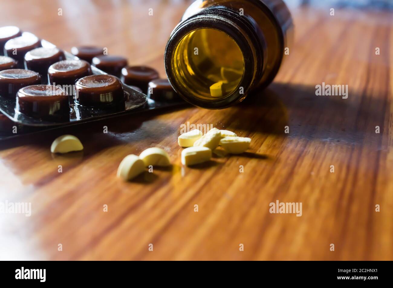 Close up Open transparent glass bottle with medicine pills or tablets ...