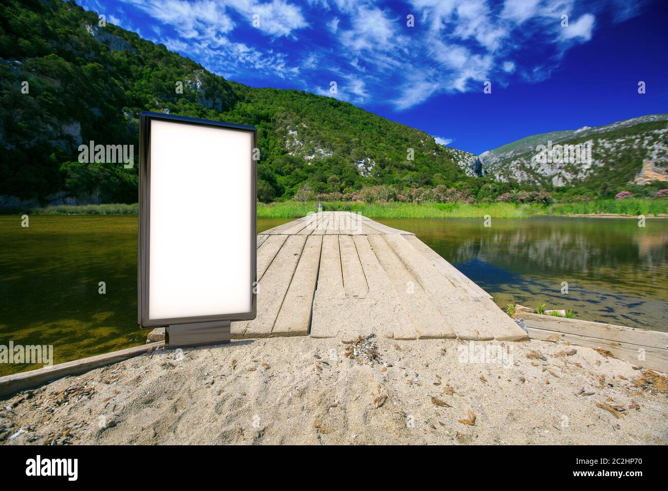 Blank advertising mockup in the street . Poster billboard on the mountains background Stock Photo